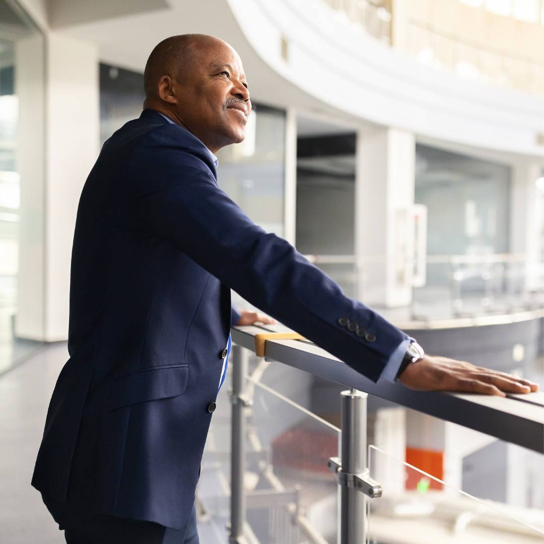 Man looking over balcony knowingly